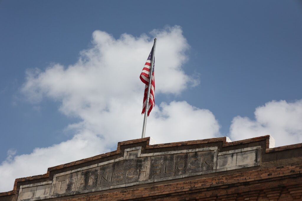 US flag at Fort Worth stockyards in Texas, showcasing Clear to Launch's expertise in dental marketing.
