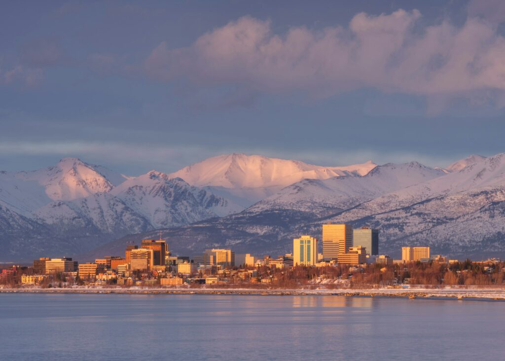 Golden hour view of Anchorage, AK skyline, highlighting Clear to Launch Dental Marketing' expertise in dental marketing and growth strategies for Anchorage dentists.