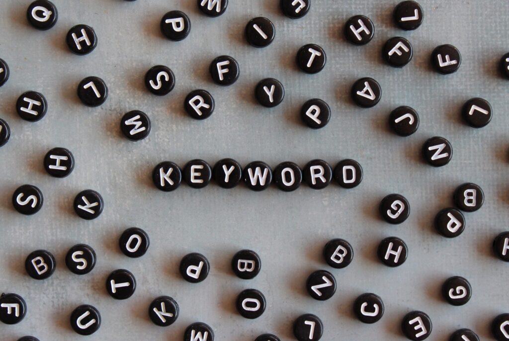 Scattered letter dice with the word "keyword" spelled out—representing how Clear to Launch Dental Marketing uncovers the right dental keywords to drive website traffic.