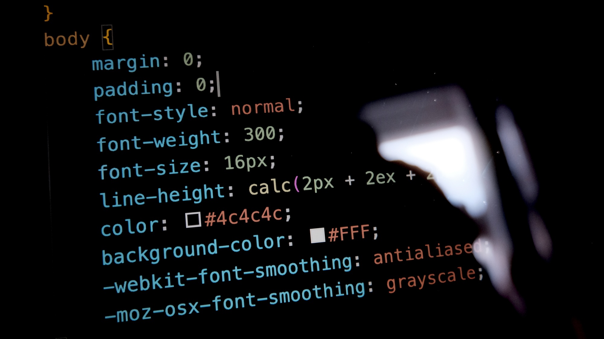 Close-up of website coding on a screen, representing the technical SEO and backend optimization that help the best dental websites rank on Google.