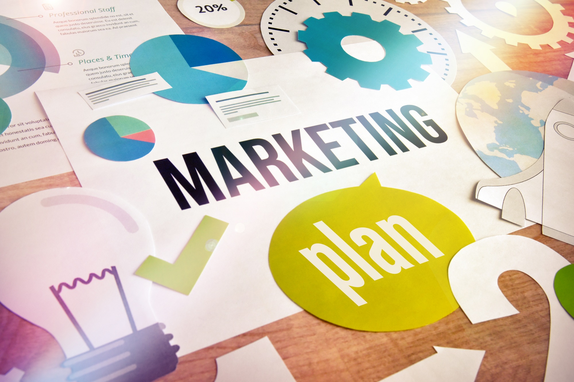 Marketing plan concept with charts, graphs, gears, and strategy icons representing a dental marketing plan for practice growth.