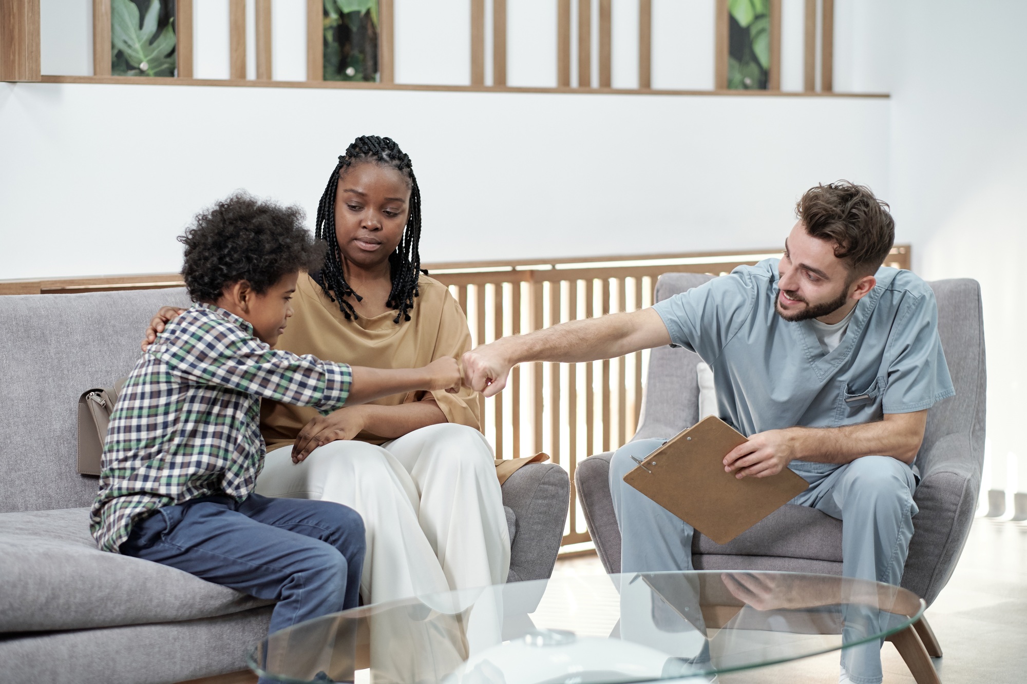 “Dentist greeting young patient and parent in office, representing how Clear to Launch Dental Marketing uses Google Ads to attract families to dental practices