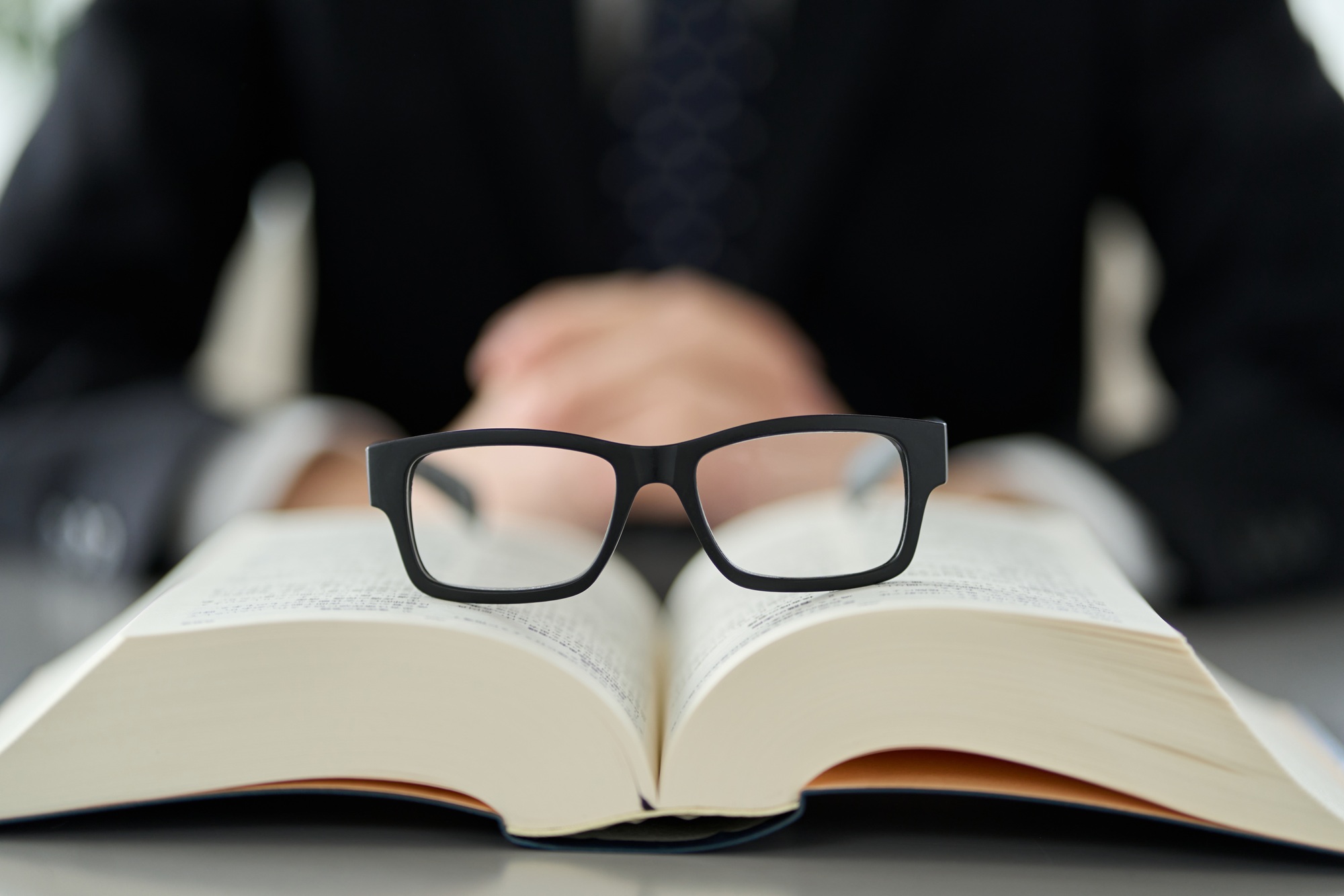 Eyeglasses resting on an open book symbolizing Clear to Launch Dental Marketing’s guide to essential dental marketing terms and their importance