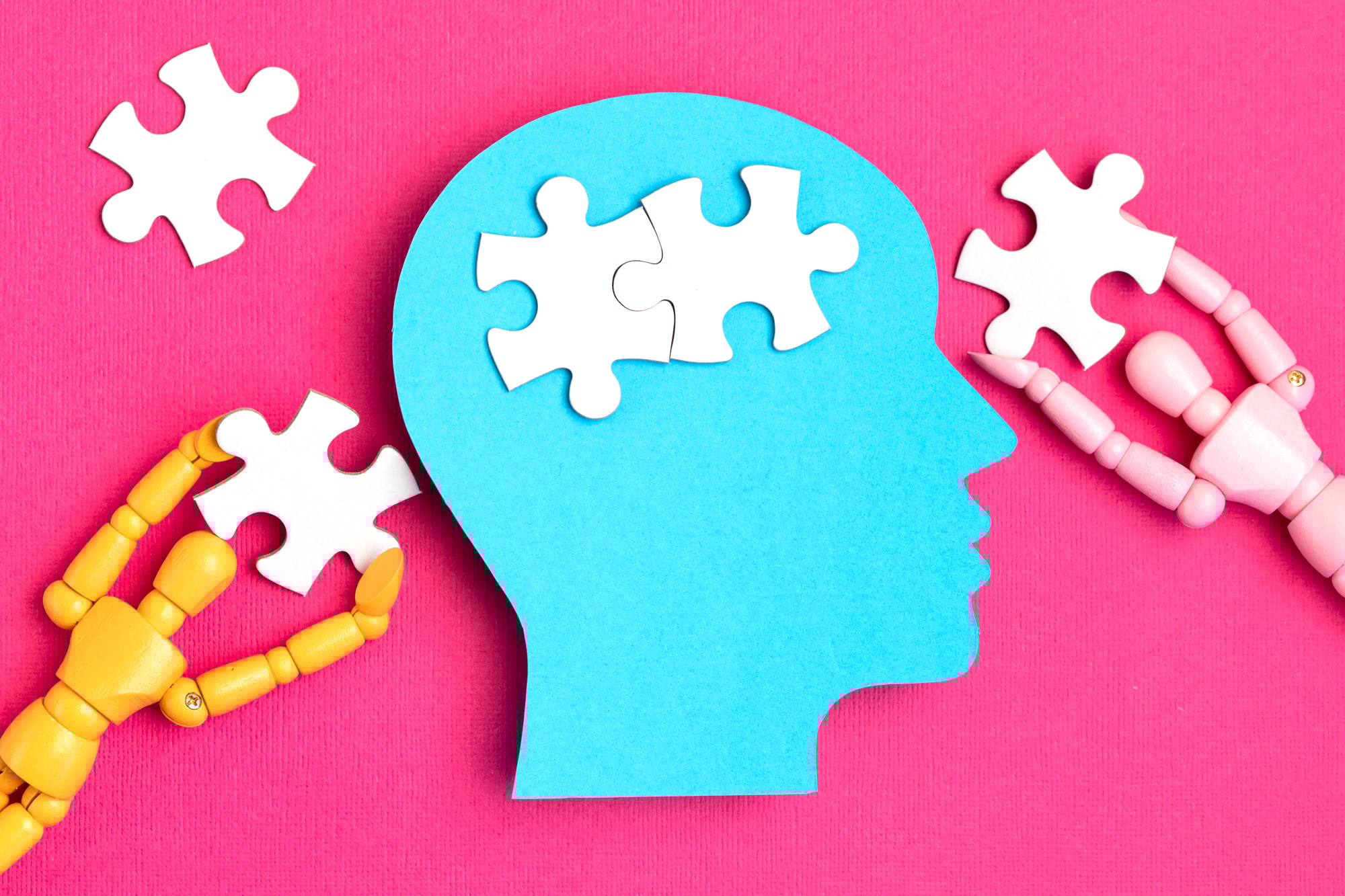 Puzzle pieces forming a brain inside a head silhouette representing Clear to Launch Dental Marketing’s insights on the psychology behind effective dental branding