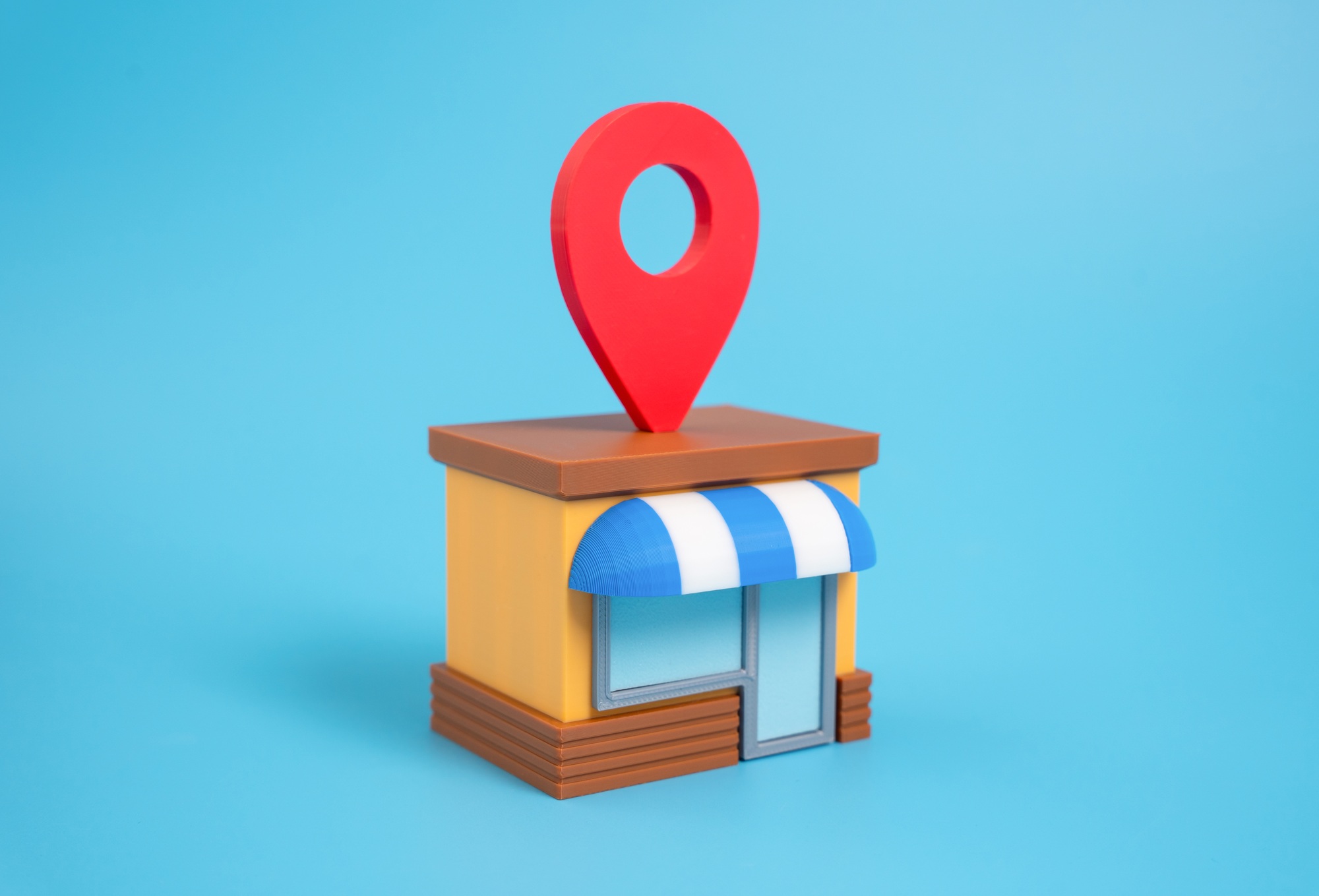 3D illustration of a storefront with location pin, representing Clear to Launch Dental Marketing’s focus on local SEO for dental practices
